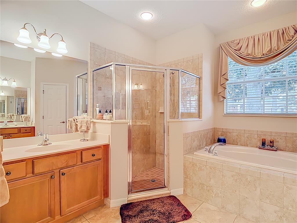 277 Magneta Loop Auburndale, FL 33823 - Photo 27 of 58 a bathroom with a sink a vanity and a mirror