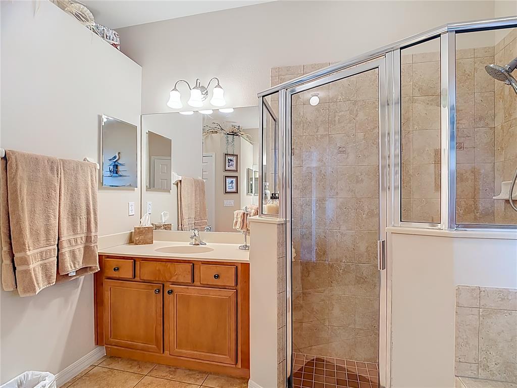 277 Magneta Loop Auburndale, FL 33823 - Photo 28 of 58 a bathroom with a double vanity sink mirror and shower