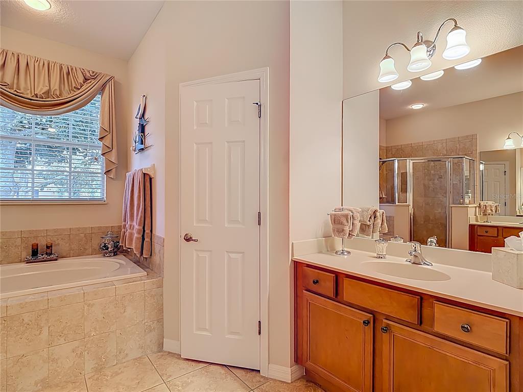 277 Magneta Loop Auburndale, FL 33823 - Photo 29 of 58 a bathroom with a sink double vanity and a mirror
