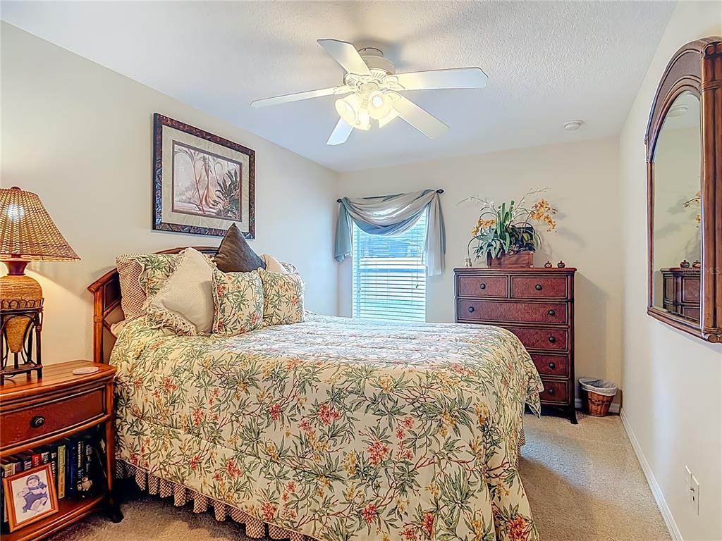 277 Magneta Loop Auburndale, FL 33823 - Photo 30 of 58 a bedroom with a bed and a chandelier