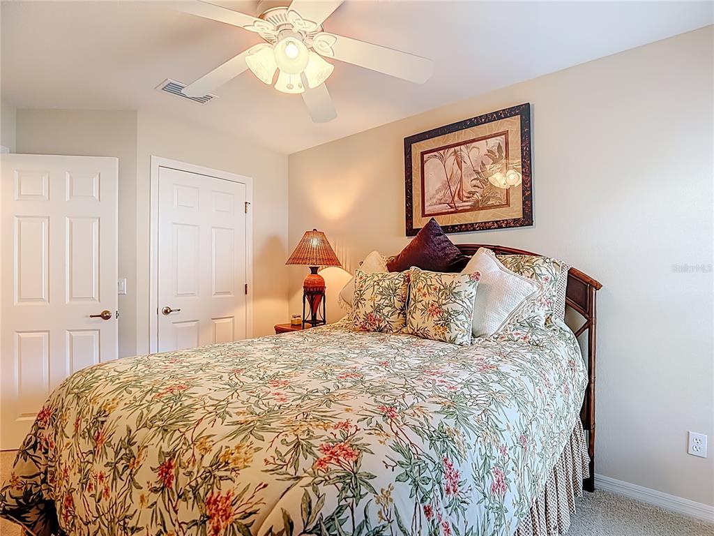 277 Magneta Loop Auburndale, FL 33823 - Photo 31 of 58 a bedroom with a bed and a chandelier
