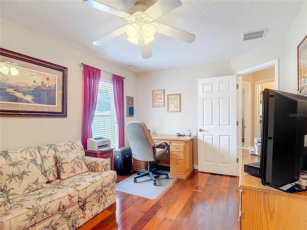 277 Magneta Loop Auburndale, FL 33823 - Photo 35 of 58 a living room with furniture flat screen tv and a refrigerator