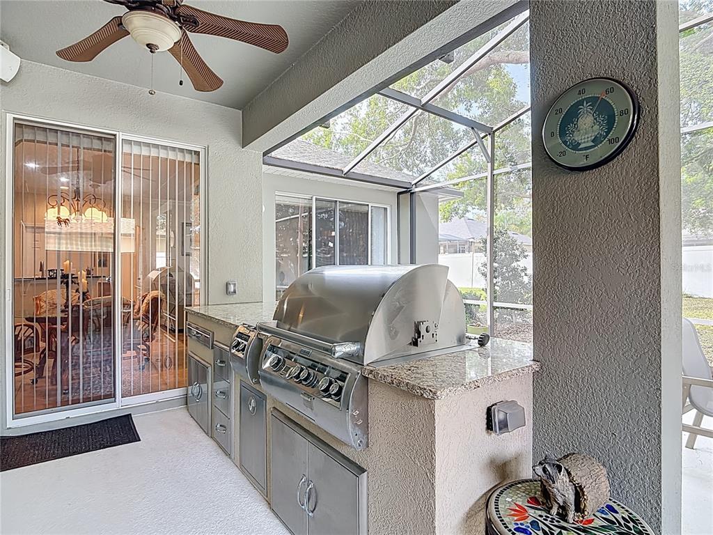 277 Magneta Loop Auburndale, FL 33823 - Photo 40 of 58 a kitchen with stainless steel appliances granite countertop a stove and a refrigerator