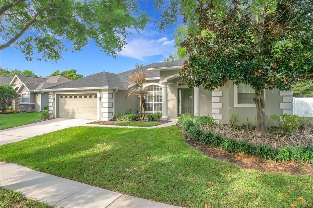 277 Magneta Loop Auburndale, FL 33823 - Photo 57 of 58 a front view of a house with a garden