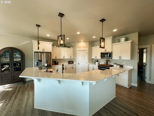 946 South Calapooia Street Sutherlin, OR 97479 - Photo 6 of 31 a large kitchen with sink a counter top space appliances and cabinets