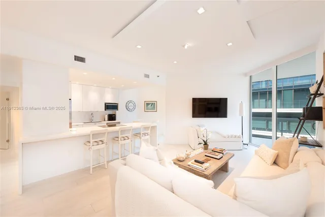 a kitchen with stainless steel appliances a stove a sink a microwave and cabinets