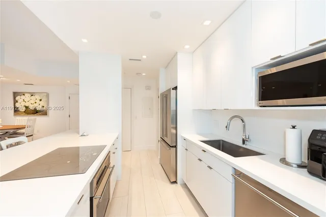 a kitchen with a sink stove and refrigerator