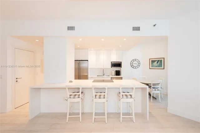 a bedroom with two bed and a flat screen tv