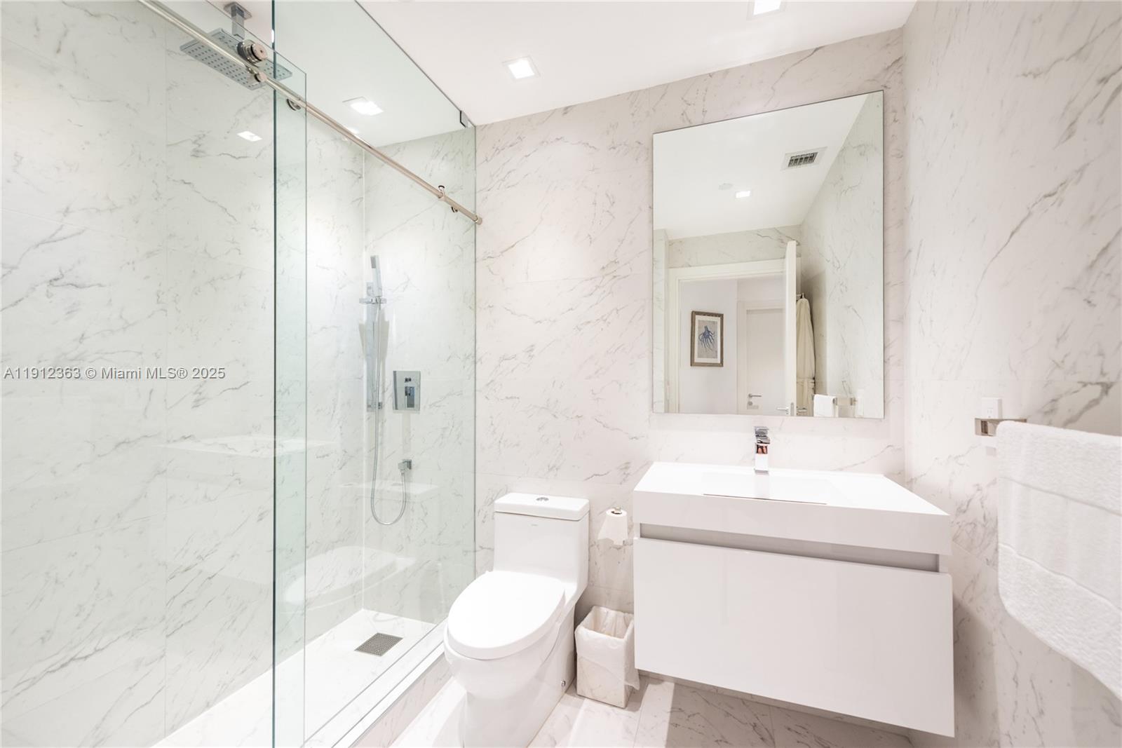 8925 Collins Avenue, Unit 11C Surfside, FL 33154 - Photo 19 of 36 a bathroom with a sink toilet and shower