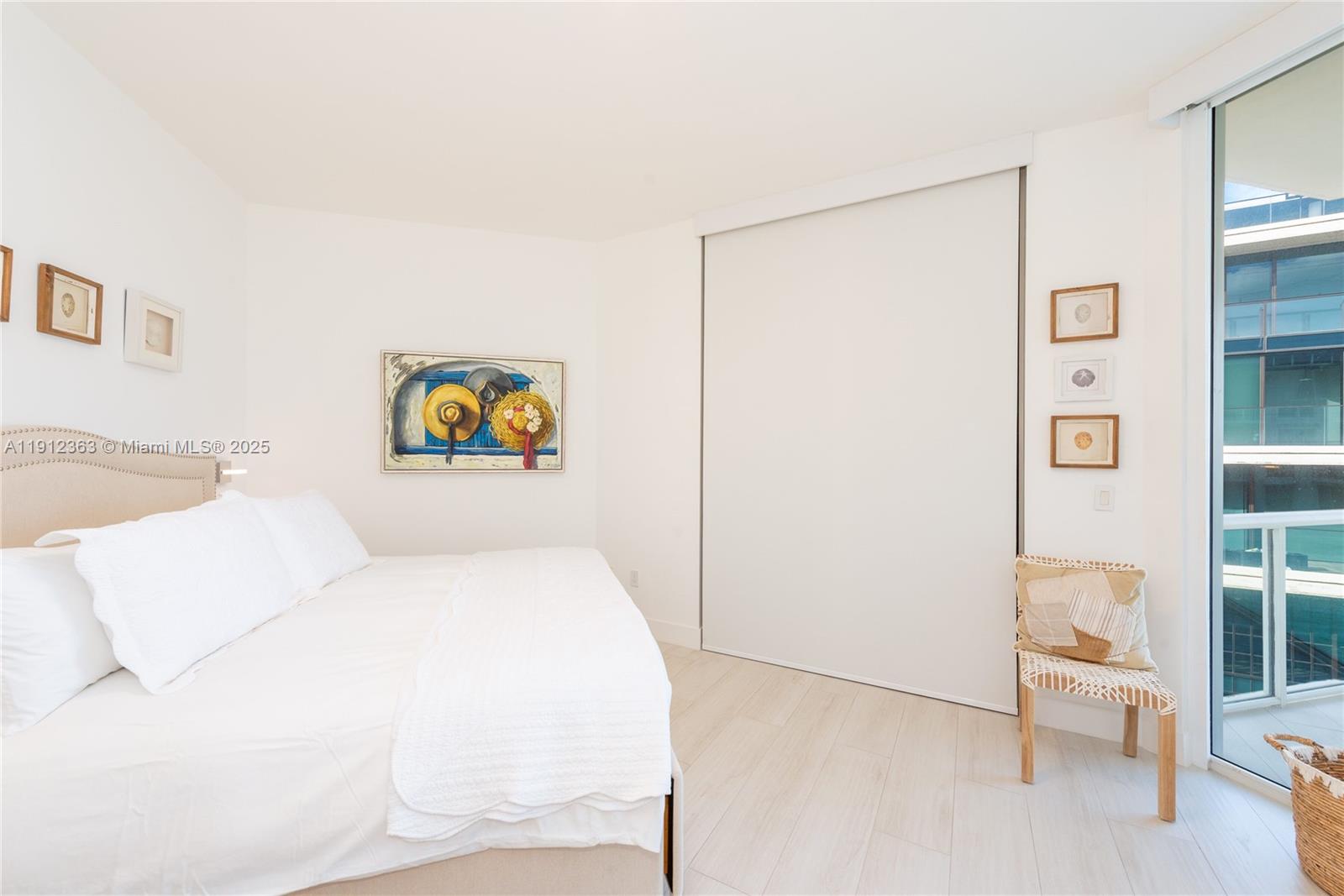 8925 Collins Avenue, Unit 11C Surfside, FL 33154 - Photo 22 of 36 a bedroom with a bed and a painting on the wall