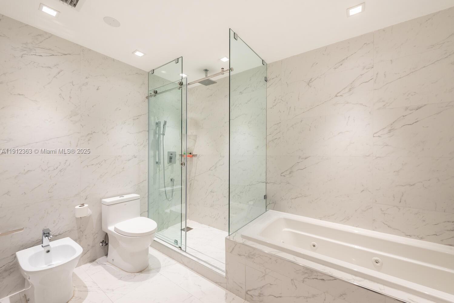 8925 Collins Avenue, Unit 11C Surfside, FL 33154 - Photo 24 of 36 a bathroom with a toilet sink and shower