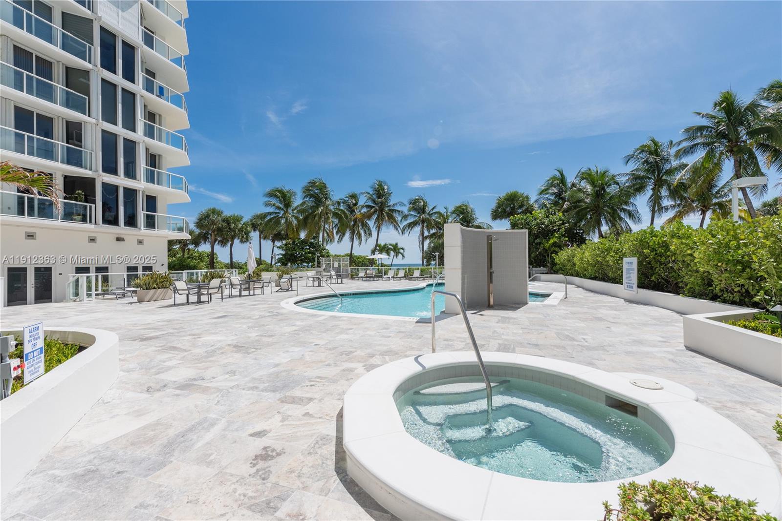 8925 Collins Avenue, Unit 11C Surfside, FL 33154 - Photo 29 of 36 a view of a swimming pool with a patio