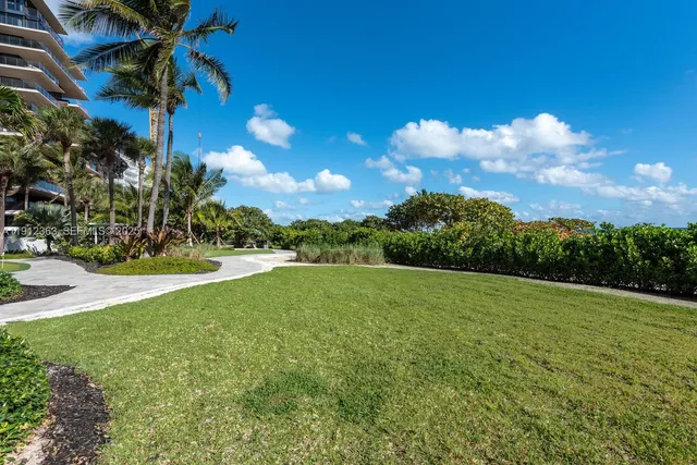 a view of a swimming pool with a yard
