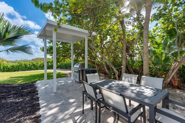 a view of a building with garden and sitting area
