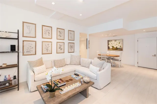 a large white room with a large window and flat screen tv