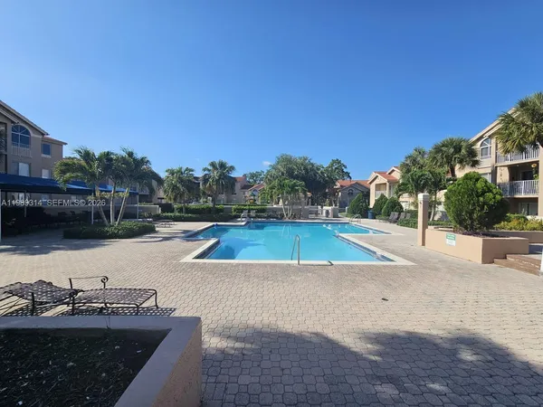 a view of a swimming pool with a yard