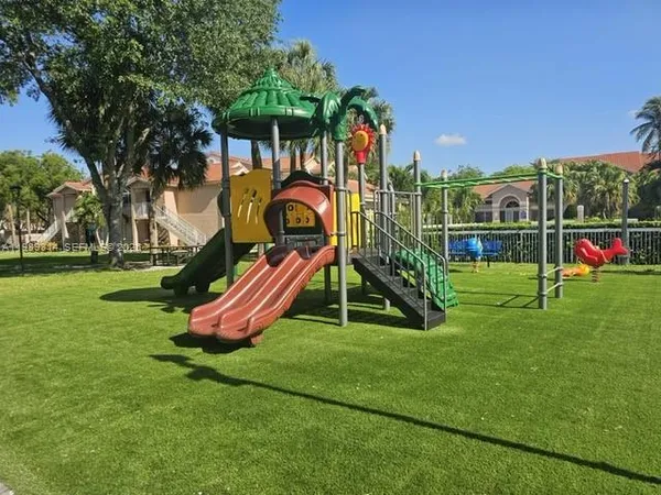 a view of a park with slide and a bench