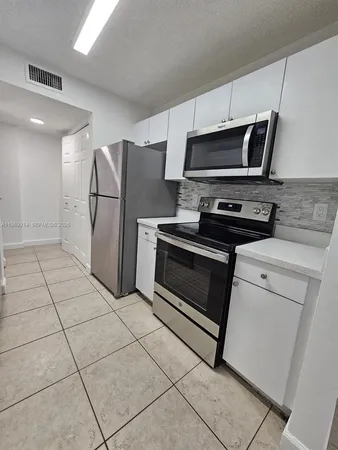 a kitchen with appliances and cabinets