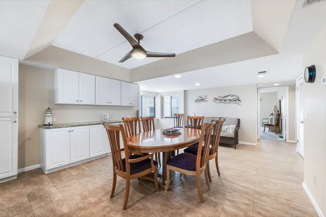 a dining room with a wooden table and chairs