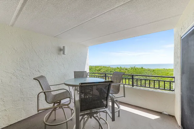 a view of a chairs and table in patio