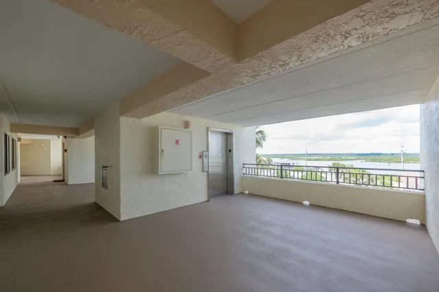 a view of an empty room with windows