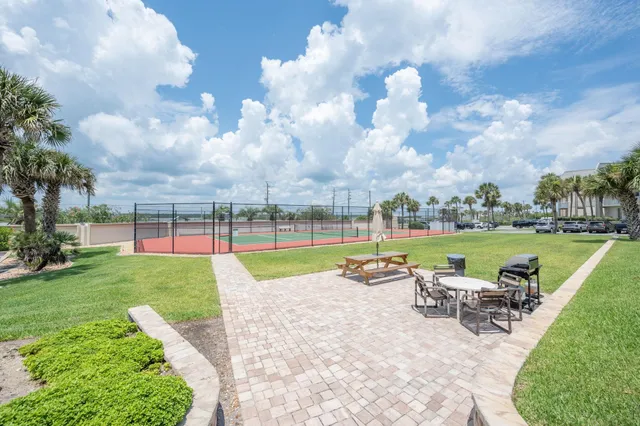 a view of a garden with lawn chairs