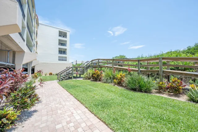 a view of a garden with a building in the background