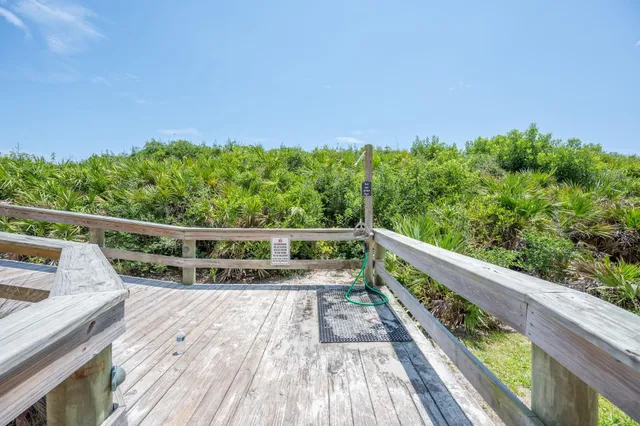 a view of balcony with wooden floor and fence