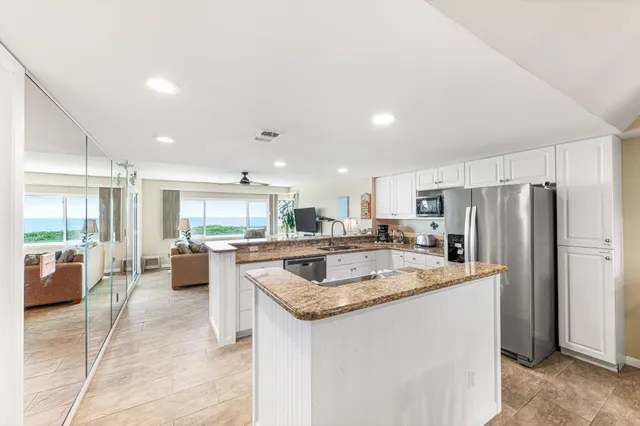a kitchen with a sink a counter top stainless steel appliances and cabinets