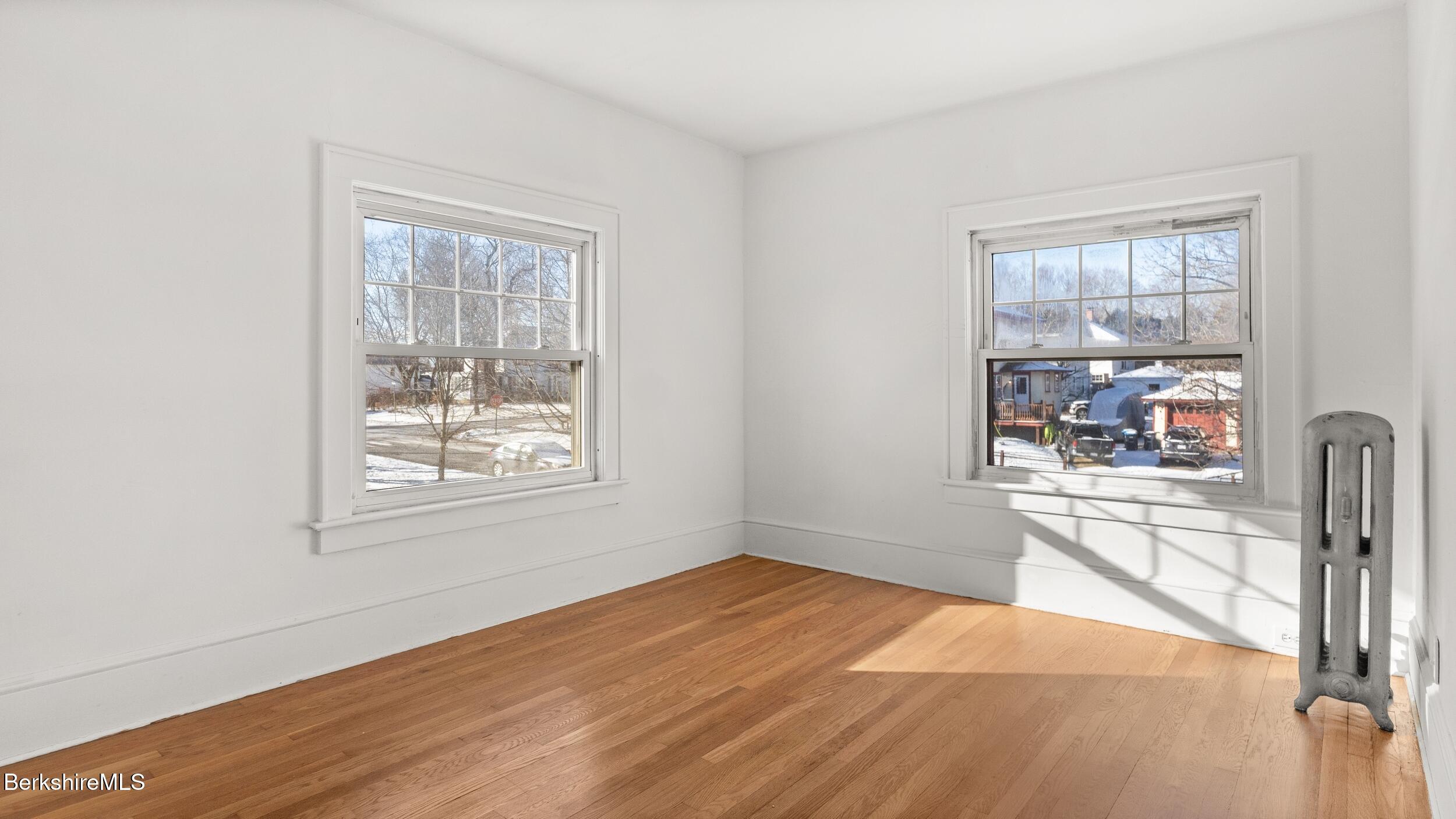 121 Edward Avenue Pittsfield, MA 01201 - Photo 11 of 22 an empty room with wooden floor and windows