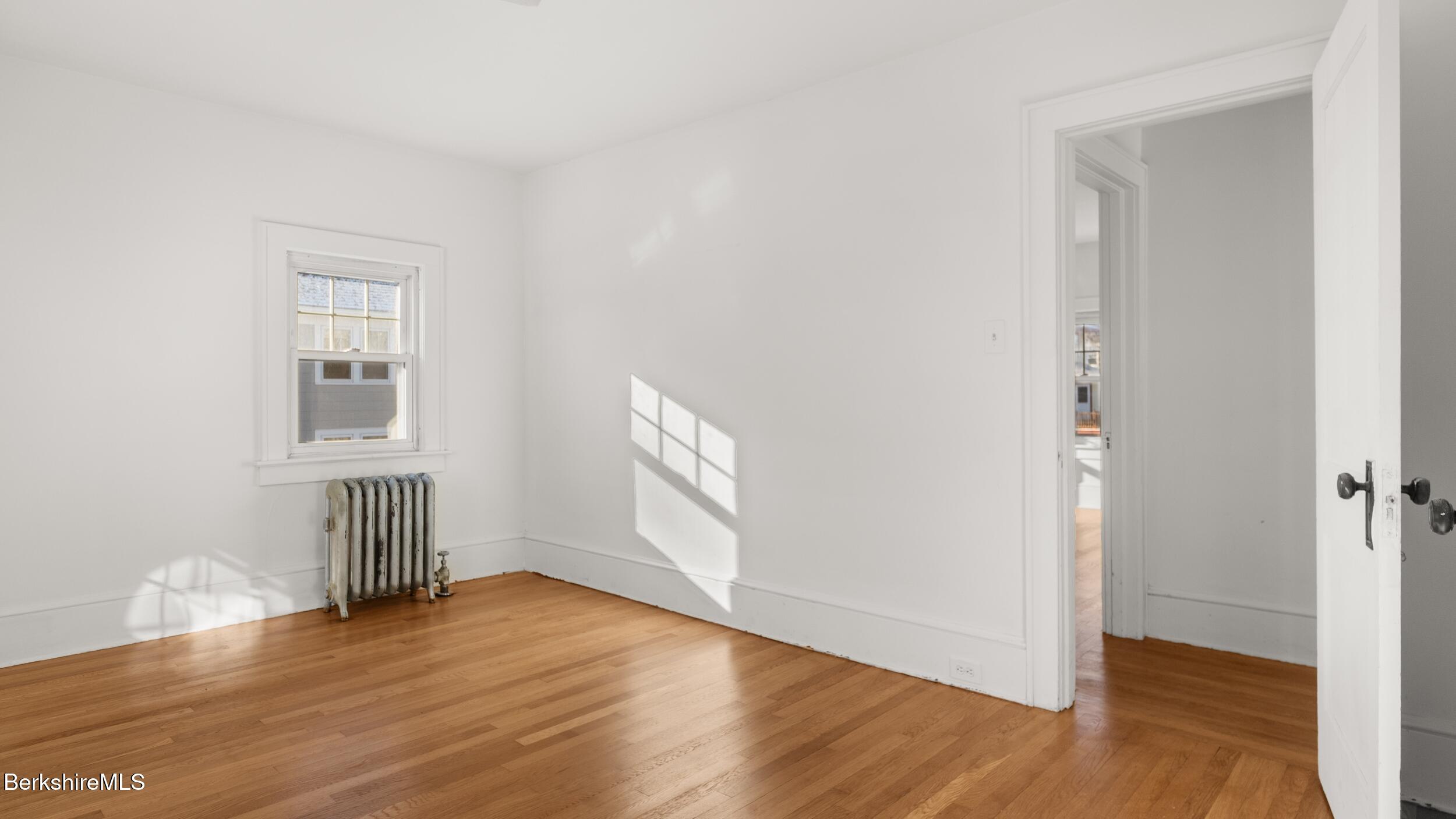 121 Edward Avenue Pittsfield, MA 01201 - Photo 14 of 22 an empty room with wooden floor and windows