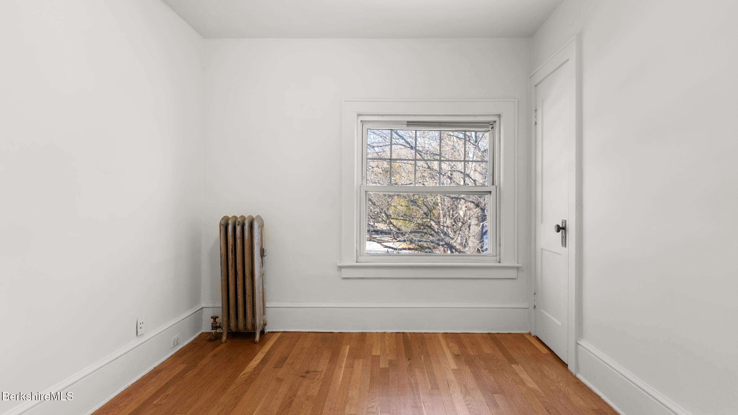 121 Edward Avenue Pittsfield, MA 01201 - Photo 15 of 22 an empty room with window and wooden floor