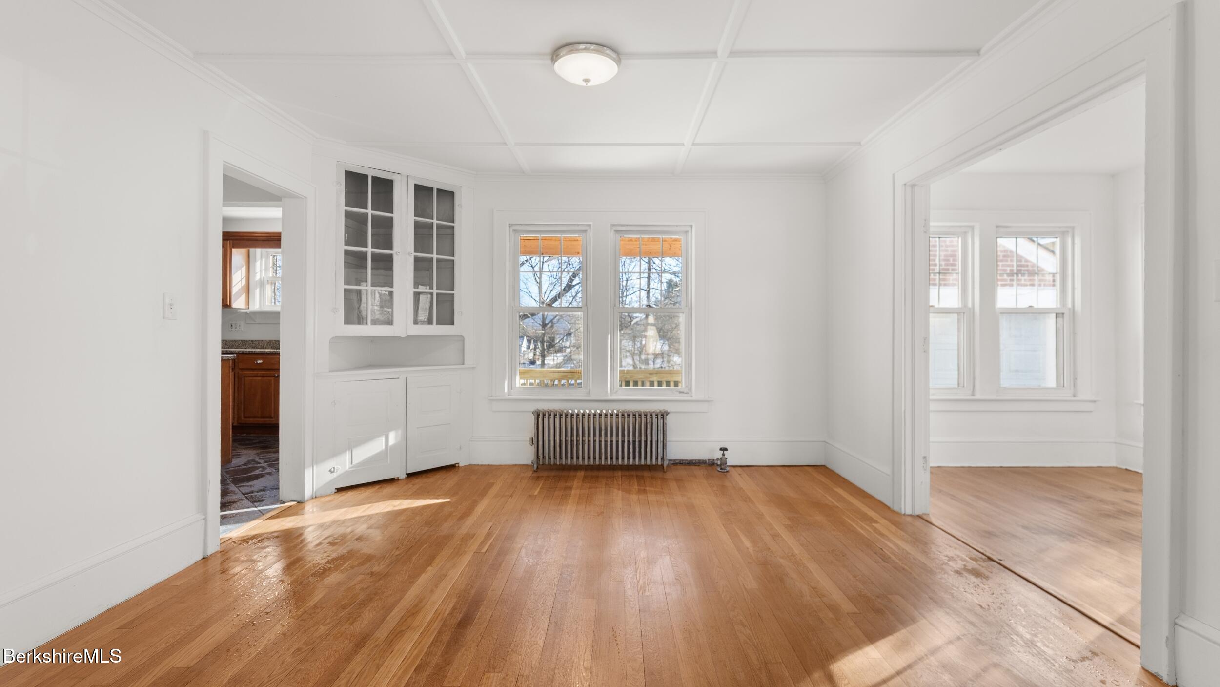 121 Edward Avenue Pittsfield, MA 01201 - Photo 19 of 22 an empty room with wooden floor and windows