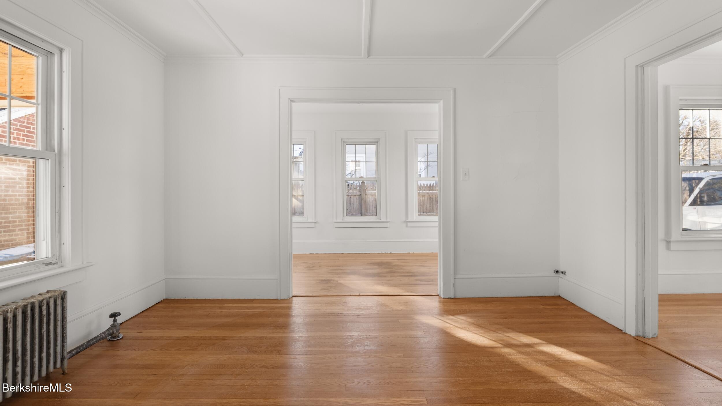 121 Edward Avenue Pittsfield, MA 01201 - Photo 20 of 22 a view of an empty room with window and wooden floor