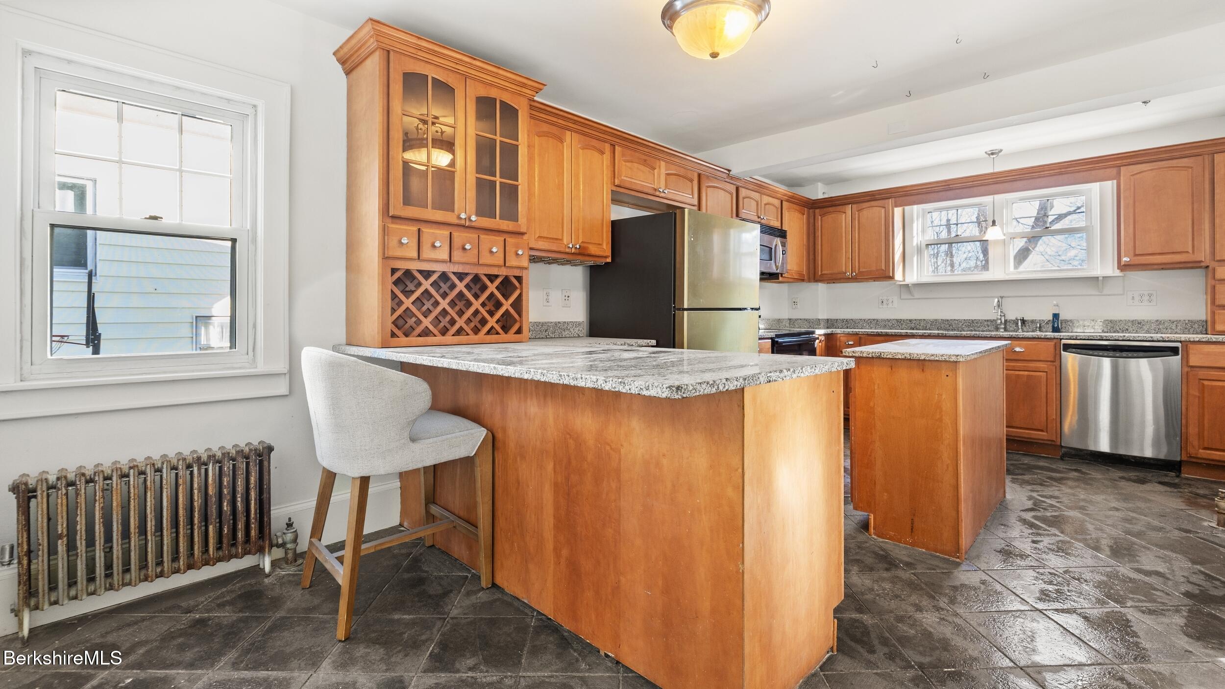 121 Edward Avenue Pittsfield, MA 01201 - Photo 8 of 22 a kitchen with stainless steel appliances granite countertop a sink and a refrigerator
