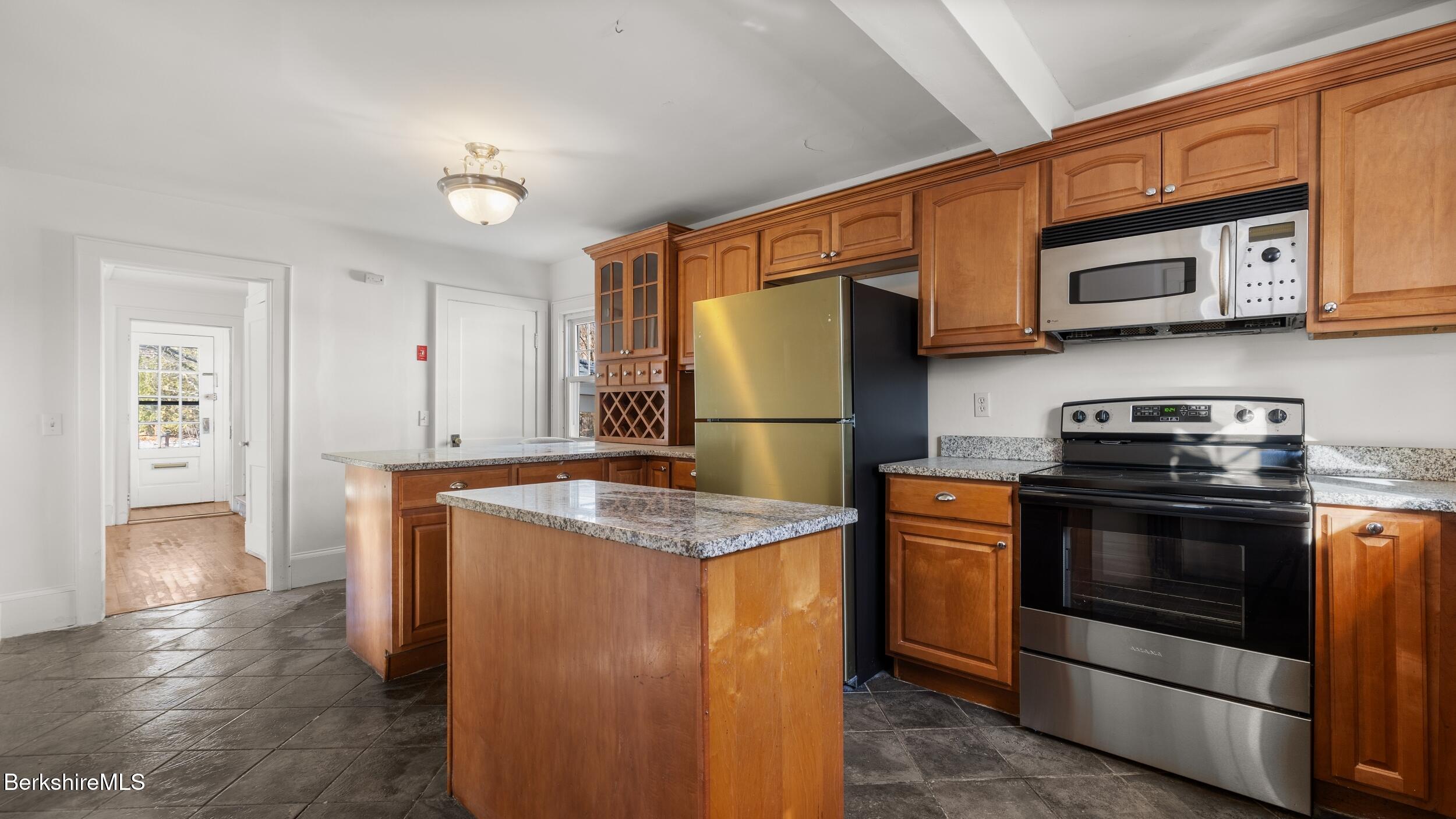 121 Edward Avenue Pittsfield, MA 01201 - Photo 9 of 22 a kitchen with stainless steel appliances granite countertop a refrigerator stove and a sink