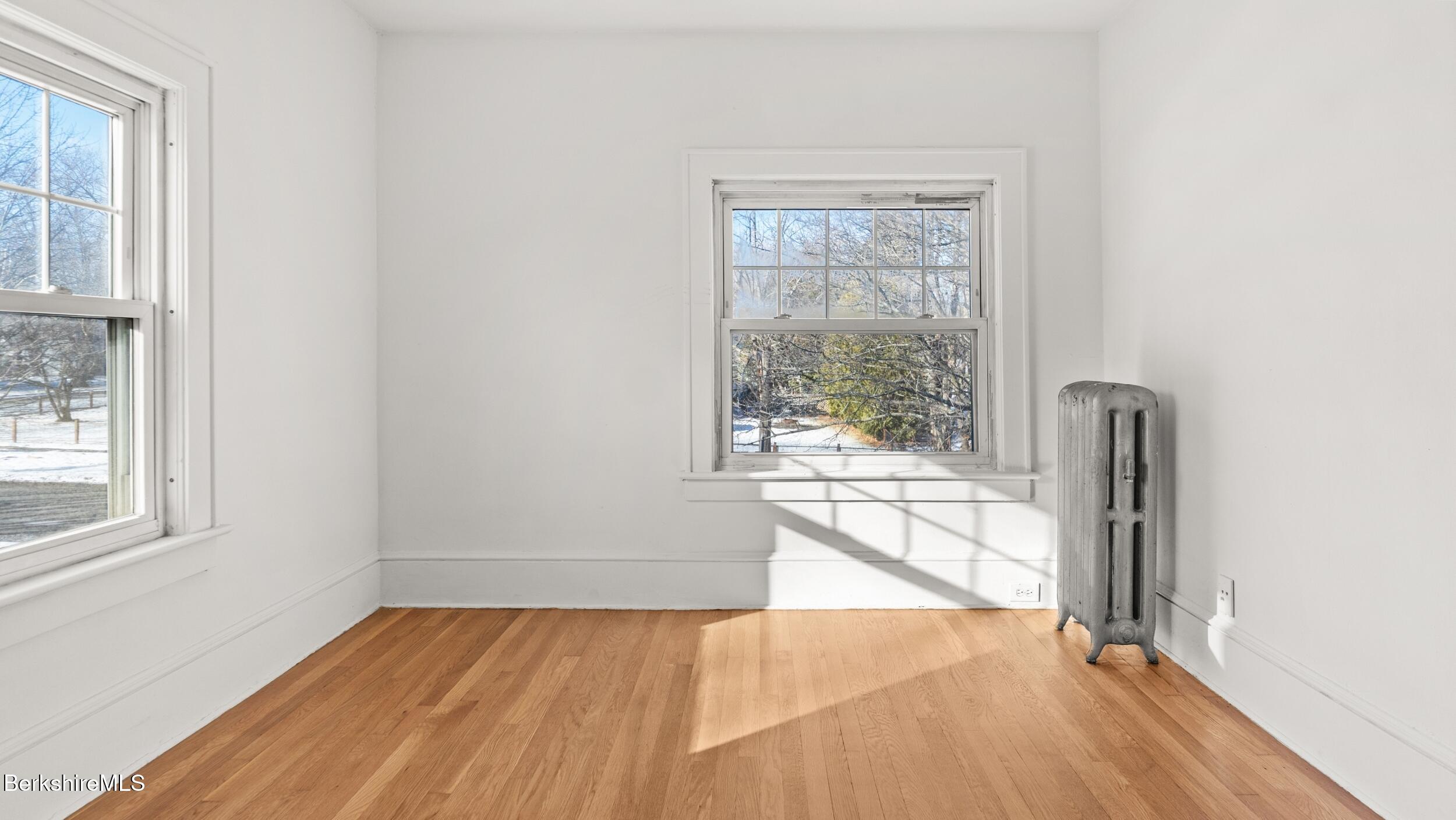 121 Edward Avenue Pittsfield, MA 01201 - Photo 10 of 22 an empty room with wooden floor and windows
