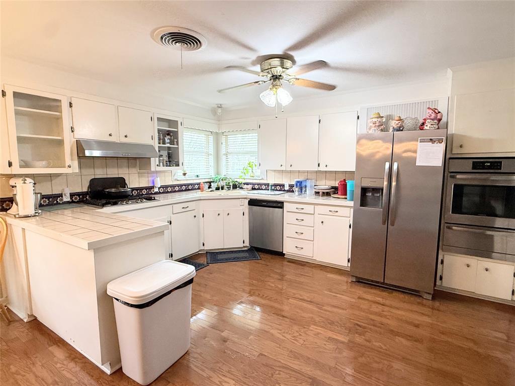 112 Meadow Lane Groesbeck, TX 76642 - Photo 15 of 37 a kitchen with a sink stainless steel appliances and white cabinets