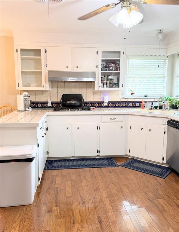 112 Meadow Lane Groesbeck, TX 76642 - Photo 16 of 37 a kitchen with stainless steel appliances granite countertop a stove a sink and white cabinets