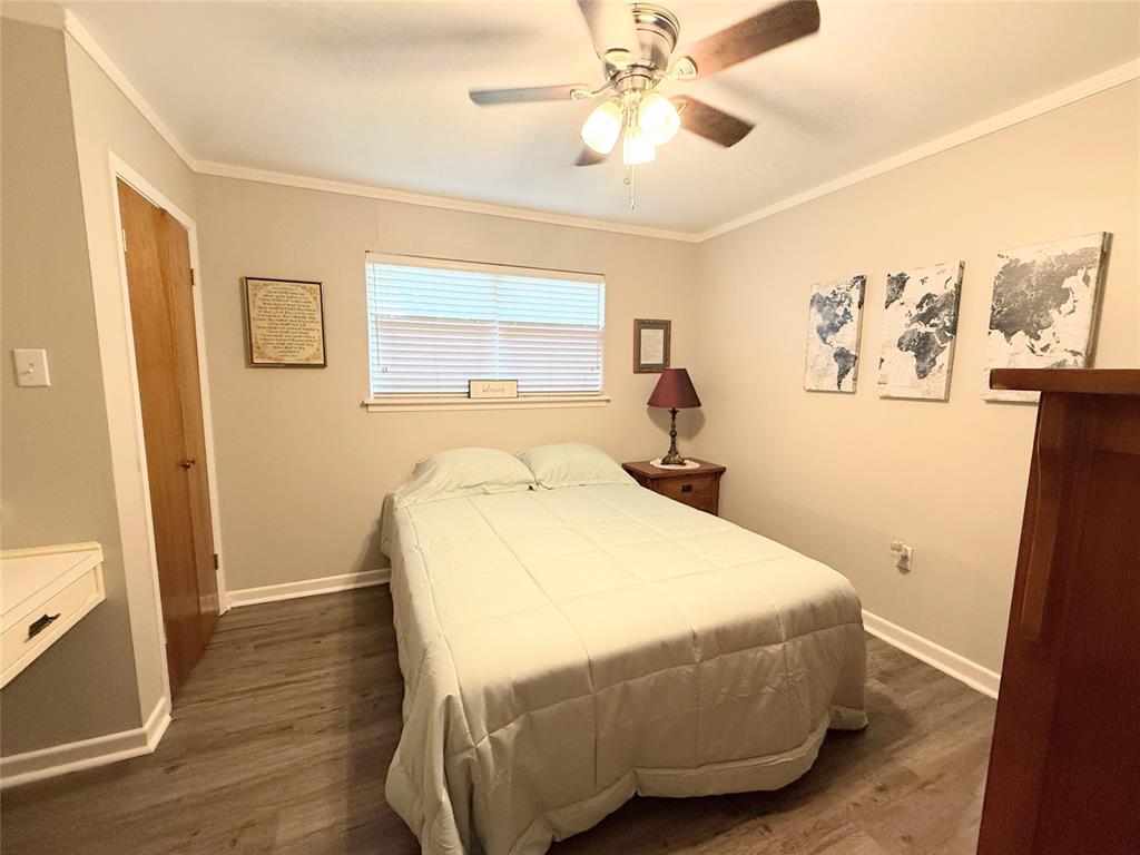 112 Meadow Lane Groesbeck, TX 76642 - Photo 24 of 37 a bedroom with a bed and wooden floor