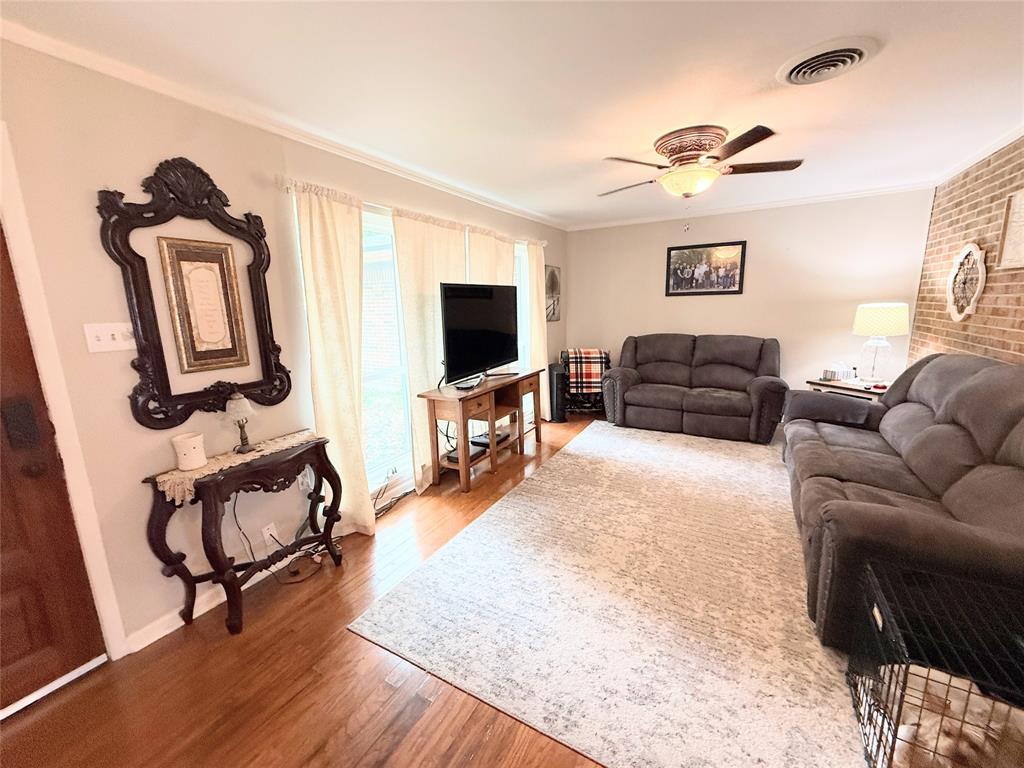 112 Meadow Lane Groesbeck, TX 76642 - Photo 4 of 37 a living room with furniture and a flat screen tv