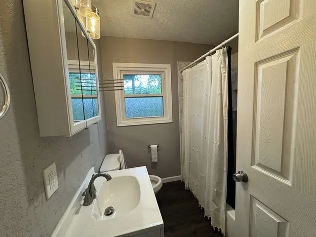 a bathroom with a sink a mirror and a shower