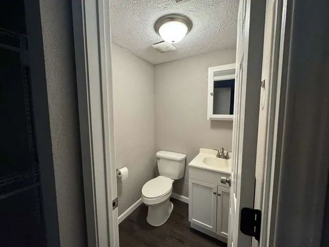 a bathroom with a toilet a sink and a mirror