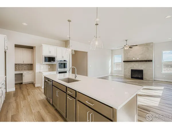 a open kitchen with kitchen island a sink stainless steel appliances and cabinets