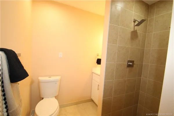 a bathroom with a toilet and a shower