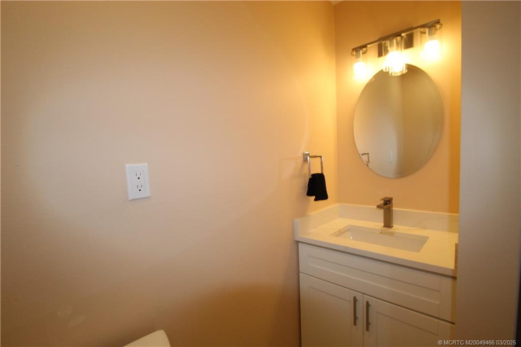 2929 Southeast Ocean Boulevard, Unit 13110 Stuart, FL 34996 - Photo 12 of 25 a bathroom with a sink and mirror