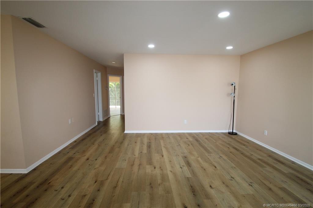 2929 Southeast Ocean Boulevard, Unit 13110 Stuart, FL 34996 - Photo 13 of 25 a view of an empty room with wooden floor