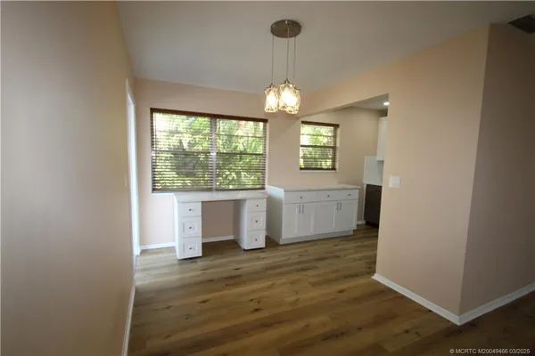 a view of a kitchen and an empty room
