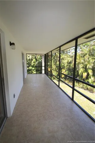 wooden floor in an empty room with a large window