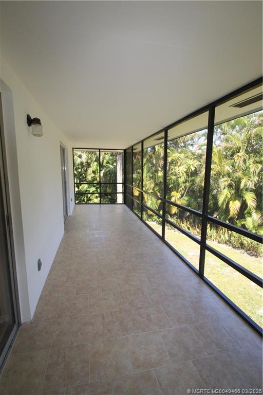2929 Southeast Ocean Boulevard, Unit 13110 Stuart, FL 34996 - Photo 19 of 25 wooden floor in an empty room with a large window